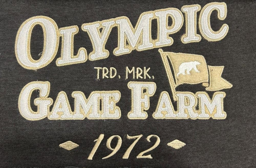 Double layer felt applique reading Olympic Game Farm 1972 on a charcoal hoodie